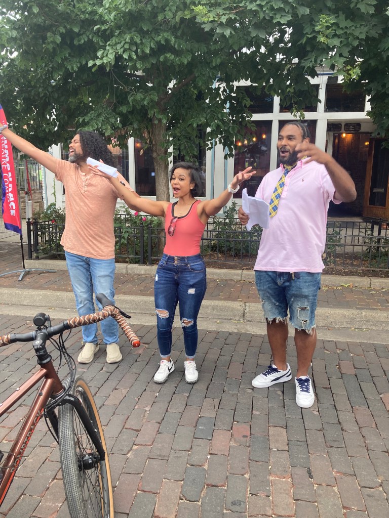 Actors Andrew Ian Adams, Bryana Bentley, and Shaun Diggs performing in the Oregon District.